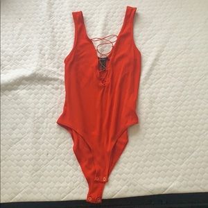 Red/orange laced body suit.